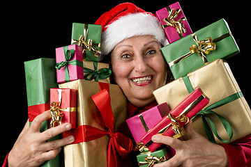 Image showing Delighted Old Lady Hugging a Dozen Wrapped Gifts
