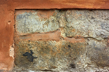 Image showing Old stone wall with plaster shelled