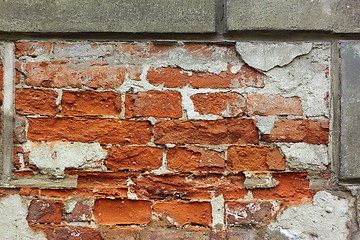 Image showing Old brick wall with plaster shelled