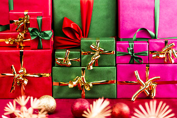 Image showing Three Stacks of Xmas Presents Arranged by Color