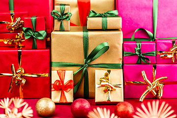 Image showing Three Heaps of Christmas Gifts Sorted by Color