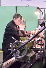 Image showing Milling-machine operator works at machine