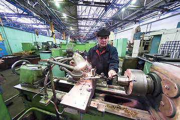 Image showing Senior milling machine operator works at machine