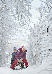 Image showing Boy And Girl at sledging Through Snowy