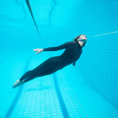 Image showing Female diver flying underwater in swimming pool