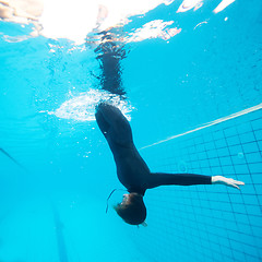 Image showing Female diving downwards in swimming pool