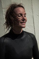 Image showing Attractive smiling female swimmer with eyes closed