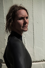 Image showing Attractive serious looking female swimmer wearing wetsuit