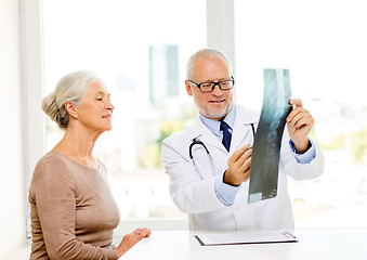 Image showing smiling senior woman and doctor meeting