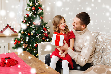 Image showing smiling father and daughter holding gift box