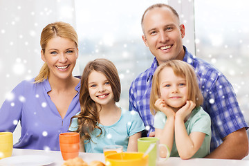 Image showing happy family with two kids having breakfast