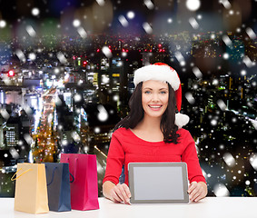 Image showing smiling woman with shopping bags and tablet pc