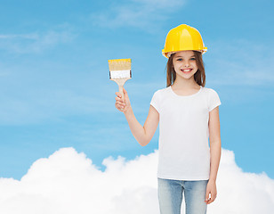 Image showing smiling little girl in helmet with paint brush