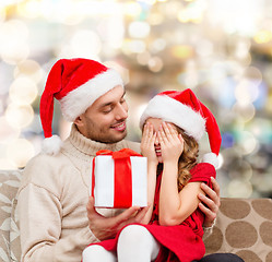 Image showing smiling daughter waiting for present from father