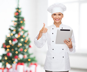 Image showing smiling chef with tablet pc showing thumbs up