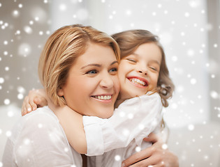 Image showing happy mother and daughter hugging at home