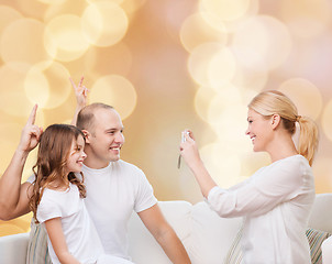 Image showing happy family with camera at home