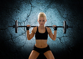 Image showing sporty woman exercising with barbell