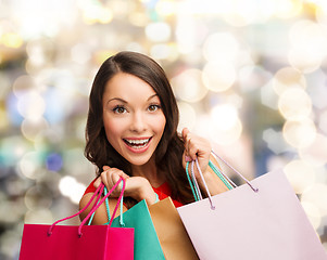 Image showing smiling woman with colorful shopping bags