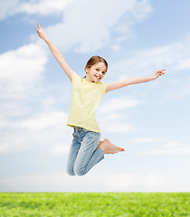 Image showing smiling little girl jumping