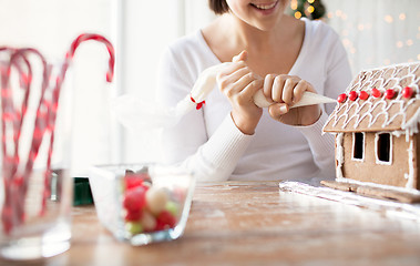 Image showing close up of woman making gingerbread houses