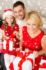 Image showing smiling family holding many gift boxes