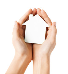 Image showing hands holding white paper house