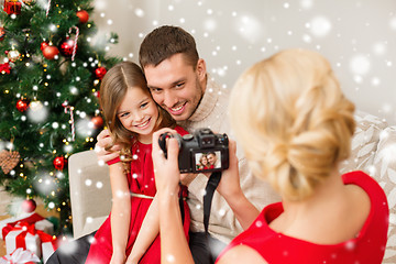 Image showing happy family with digital camera taking photo