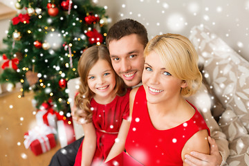Image showing smiling family holding gift box