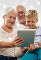 Image showing smiling family with tablet pc at home