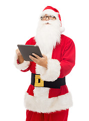 Image showing man in costume of santa claus with tablet pc