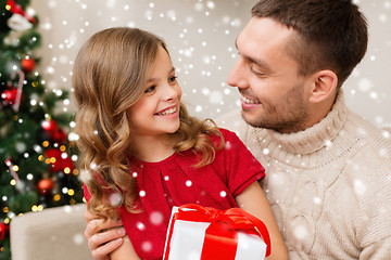 Image showing smiling father and daughter holding gift box