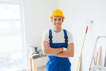 Image showing smiling young builder in hardhat  indoors