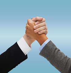 Image showing close up of two hands multiracial armwrestling