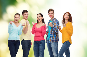 Image showing group of smiling teenagers over green background