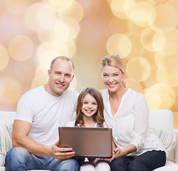 Image showing smiling family with laptop