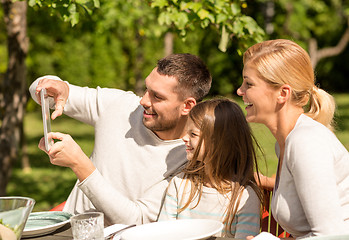 Image showing happy family with tablet pc outdoors