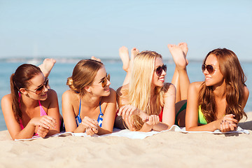 Image showing group of smiling women in sunglasses on beach