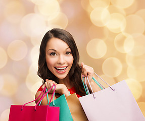 Image showing smiling woman with colorful shopping bags