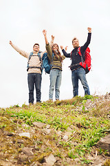 Image showing group of smiling friends with backpacks hiking