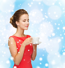 Image showing smiling woman in red dress with cup of coffee