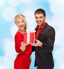 Image showing smiling man and woman with present