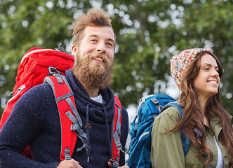 Image showing group of smiling friends with backpacks hiking