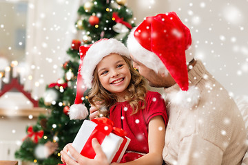 Image showing smiling father and daughter holding gift box