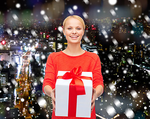 Image showing smiling woman in red clothes with gift box
