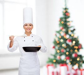 Image showing smiling female chef with pan and spoon