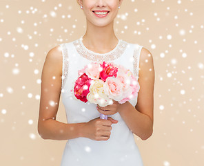 Image showing close up of woman in white dress with flowers