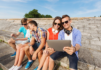 Image showing group of smiling friends with tablet pc outdoors