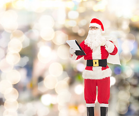 Image showing man in costume of santa claus with notepad and bag
