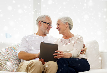 Image showing happy senior couple with tablet pc at home